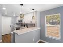 Updated kitchen featuring modern white cabinets, stone countertops, and stainless steel appliances at 1002 S Locust Ave, Sanford, FL 32771