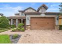 Beautiful home with a brick-paved driveway and stone-accented facade at 1365 Tappie Toorie Cir, Lake Mary, FL 32746