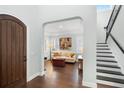 Elegant living room with hardwood floors, archway, and staircase at 1365 Tappie Toorie Cir, Lake Mary, FL 32746