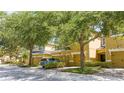 Street view of townhomes with a car parked, showcasing the well-kept facades and mature landscaping at 14231 Desert Haven St # Ge, Windermere, FL 34786