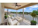 Relaxing balcony overlooking a serene lake, furnished with comfortable seating and ceiling fan at 1425 Riviera Dr, Kissimmee, FL 34744