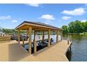 Covered boat dock with boat lift, providing easy access to the lake at 1425 Riviera Dr, Kissimmee, FL 34744