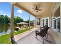 Covered patio with ceiling fan, offering stunning lake views and access to the boat dock at 1425 Riviera Dr, Kissimmee, FL 34744