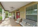 Inviting porch with comfortable seating, ceiling fan, and charming 'Welcome' sign at 17523 Doris St, Montverde, FL 34756