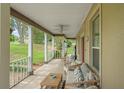 Inviting porch with comfortable seating, ceiling fan, and picturesque views at 17523 Doris St, Montverde, FL 34756