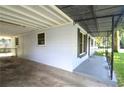 Exterior view of home featuring a covered carport and shaded front porch at 1975 Waldo St, Orlando, FL 32806