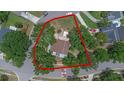 Aerial view of a lot surrounded by trees and a red outline, situated within a residential neighborhood at 202 Ferryboat Ct, Orlando, FL 32828