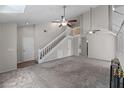 Open concept living room with staircase and ceiling fans at 202 Ferryboat Ct, Orlando, FL 32828