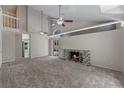 Bright living room featuring vaulted ceilings, fireplace, and sliding glass doors at 202 Ferryboat Ct, Orlando, FL 32828