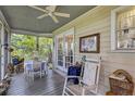 Enclosed porch with furniture for relaxing, featuring a ceiling fan, and beautiful views of nature at 2132 Palm Vista Dr, Apopka, FL 32712