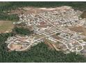 Aerial shot displaying the property within its neighborhood, highlighting the community layout and surrounding green spaces at 2305 Rio Grande Forest Ln, Kissimmee, FL 34759