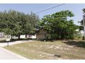 Exterior shot of house with mature trees; showcases the two-car garage, front lawn, and overall curb appeal at 2305 Rio Grande Forest Ln, Kissimmee, FL 34759