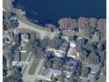 Aerial view of a property showcasing its location within a neighborhood and proximity to a serene lake at 240 Cambridge Blvd, Winter Park, FL 32789