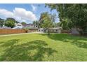 Expansive backyard featuring lush green grass and a privacy fence, offering ample space for outdoor activities at 240 Cambridge Blvd, Winter Park, FL 32789