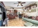 Open-concept living room and kitchen with tile floors and ceiling fan at 240 W Grossenbacher Dr, Apopka, FL 32712