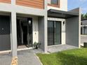 Modern townhouse exterior with covered patio and private entrance at 3301 Tranquil Trl, Kissimmee, FL 34747