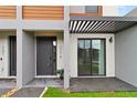 Modern townhome featuring a gray door and a cozy outdoor seating area at 3301 Tranquil Trl, Kissimmee, FL 34747