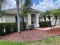 Attractive exterior with a tile roof, manicured bushes and palm trees, plus a brick-lined walkway at 4034 Bougainvillea Pl, Kissimmee, FL 34746