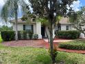 Inviting single-story home with lush landscaping, mulch beds, and a brick walkway at 4034 Bougainvillea Pl, Kissimmee, FL 34746