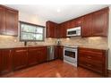 Well-equipped kitchen with custom cabinets, stainless steel appliances, and granite countertops at 414 Bonifay Ave, Orlando, FL 32825