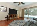 Cozy living room with a large TV, comfortable seating, and a sliding glass door to the pool area at 414 Bonifay Ave, Orlando, FL 32825