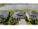 Aerial view of the home with a large lake in the background and a well-manicured lawn at 4632 Egg Harbor Dr, Kissimmee, FL 34746