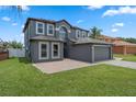 Stunning two-story home featuring a well-manicured lawn, neutral exterior paint, and spacious driveway at 470 Regal Downs Cir, Winter Garden, FL 34787