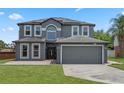 Charming two-story home with a spacious driveway, well-maintained lawn, and welcoming front entrance at 470 Regal Downs Cir, Winter Garden, FL 34787