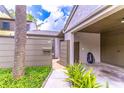 Charming pathway leading to the front entrance with a covered carport and lush landscaping at 489 Meadowood Blvd, Fern Park, FL 32730