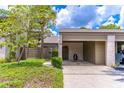 Charming exterior view featuring a covered carport, lush landscaping, and neutral color palette at 489 Meadowood Blvd, Fern Park, FL 32730