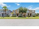 Street view of a two story home with stone accents, attractive landscaping, and a well-maintained lawn at 5217 Creekside Park Ave, Orlando, FL 32811