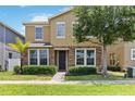 Attractive two-story home with a stone-accented facade, a well-kept lawn, and a paved walkway to the front door at 5217 Creekside Park Ave, Orlando, FL 32811