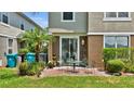 Outdoor patio featuring brick-paved flooring, patio furniture set, and lush landscaping at 6462 S Goldenrod Rd # 31B, Orlando, FL 32822