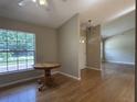 Dining room features hardwood floors and bright window; perfect for intimate meals or entertaining guests at 6610 Pampus Dr, Orlando, FL 32819