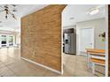 Open-concept design with a distinctive wood accent wall leading to the kitchen at 826 Sheen Cir Cir, Haines City, FL 33844