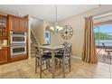 Cozy dining area offering tile floors, a pendant light, and direct access to the outdoor patio at 827 Timber Isle Dr, Orlando, FL 32828