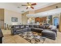 Bright living room featuring tile floors, a large sectional sofa, and seamless flow to the kitchen at 827 Timber Isle Dr, Orlando, FL 32828