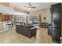 Open-concept living room with tile flooring, a ceiling fan, and a large sectional sofa at 827 Timber Isle Dr, Orlando, FL 32828