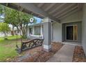 Inviting front porch featuring a decorative swing and a manicured garden at 885 Little Bend Rd, Altamonte Springs, FL 32714