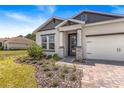A charming single-Gathering home featuring a well-manicured front lawn and a welcoming entrance at 1249 Champions Dr, Daytona Beach, FL 32124