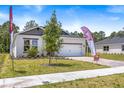 This attractive single-Gathering home features a well-maintained lawn and a two-car garage at 1249 Champions Dr, Daytona Beach, FL 32124