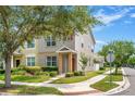 View of the exterior showing a townhome with manicured lawn and sidewalk on a beautiful sunny day at 12963 Garridan Ave, Windermere, FL 34786
