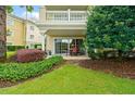 The backyard features manicured landscaping, a patio, and glass doors leading to the home's interior at 1354 Centre Court Ridge Dr # 104, Reunion, FL 34747