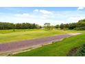 The property offers scenic views of the lush green golf course and surrounding greenery at 1354 Centre Court Ridge Dr # 104, Reunion, FL 34747