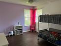 Cozy bedroom with a bunk bed, laminate floors, and a window, providing a comfortable and playful space at 1445 Valley Pine Cir, Apopka, FL 32712