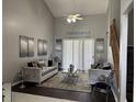 Inviting living room featuring modern decor, high ceilings, lots of natural light, and a ceiling fan at 1445 Valley Pine Cir, Apopka, FL 32712