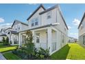 Charming two-story home with modern design, a cozy front porch, and well-manicured landscaping at 16454 Silver Brook Way, Winter Garden, FL 34787
