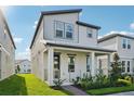 Charming two-story home with modern design, a cozy front porch, and well-manicured landscaping at 16454 Silver Brook Way, Winter Garden, FL 34787