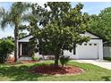 Inviting home featuring a well-maintained lawn, mature trees, and a welcoming facade at 2524 Shadybranch Dr, Orlando, FL 32822