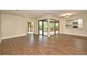 Open-concept living room featuring wood-look tile flooring and sliding glass doors at 2524 Shadybranch Dr, Orlando, FL 32822